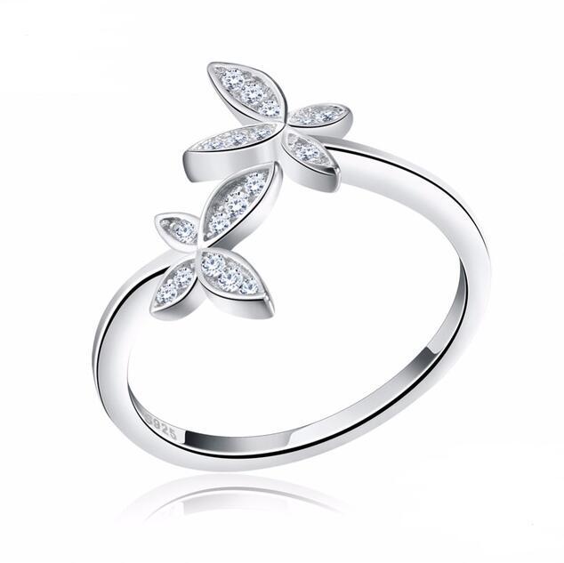 Silver ring with leaf-shaped gemstones on a white background