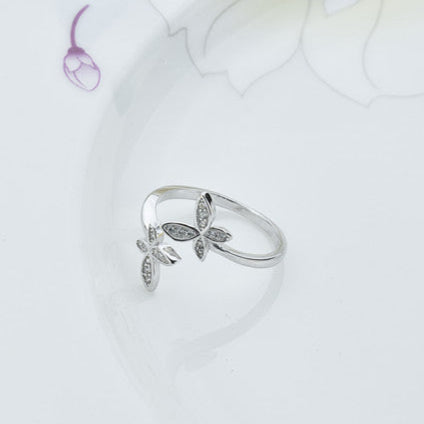 Silver butterfly ring on a light background