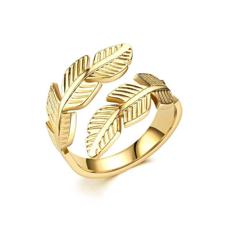 Gold ring with leaf designs on a white background