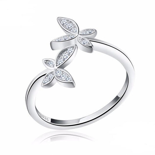 Silver ring with leaf-shaped gemstones on a white background